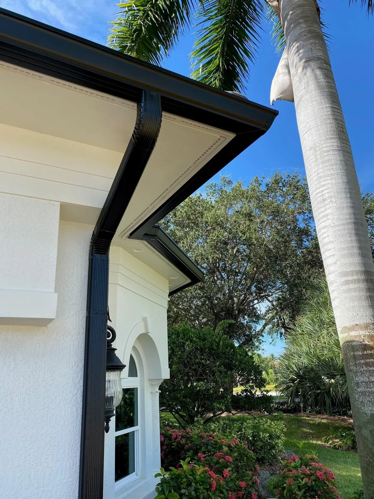 Residential gutter installation along a finished roofline