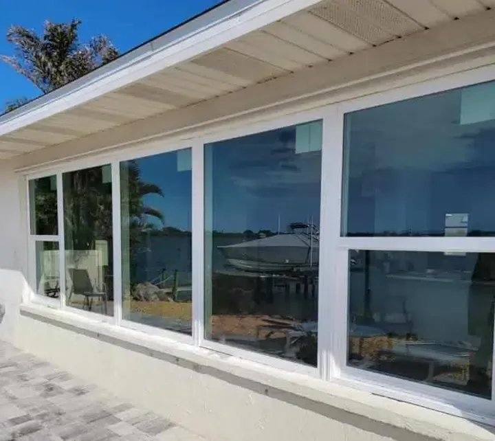 Waterfront exterior featuring wide impact-resistant windows
